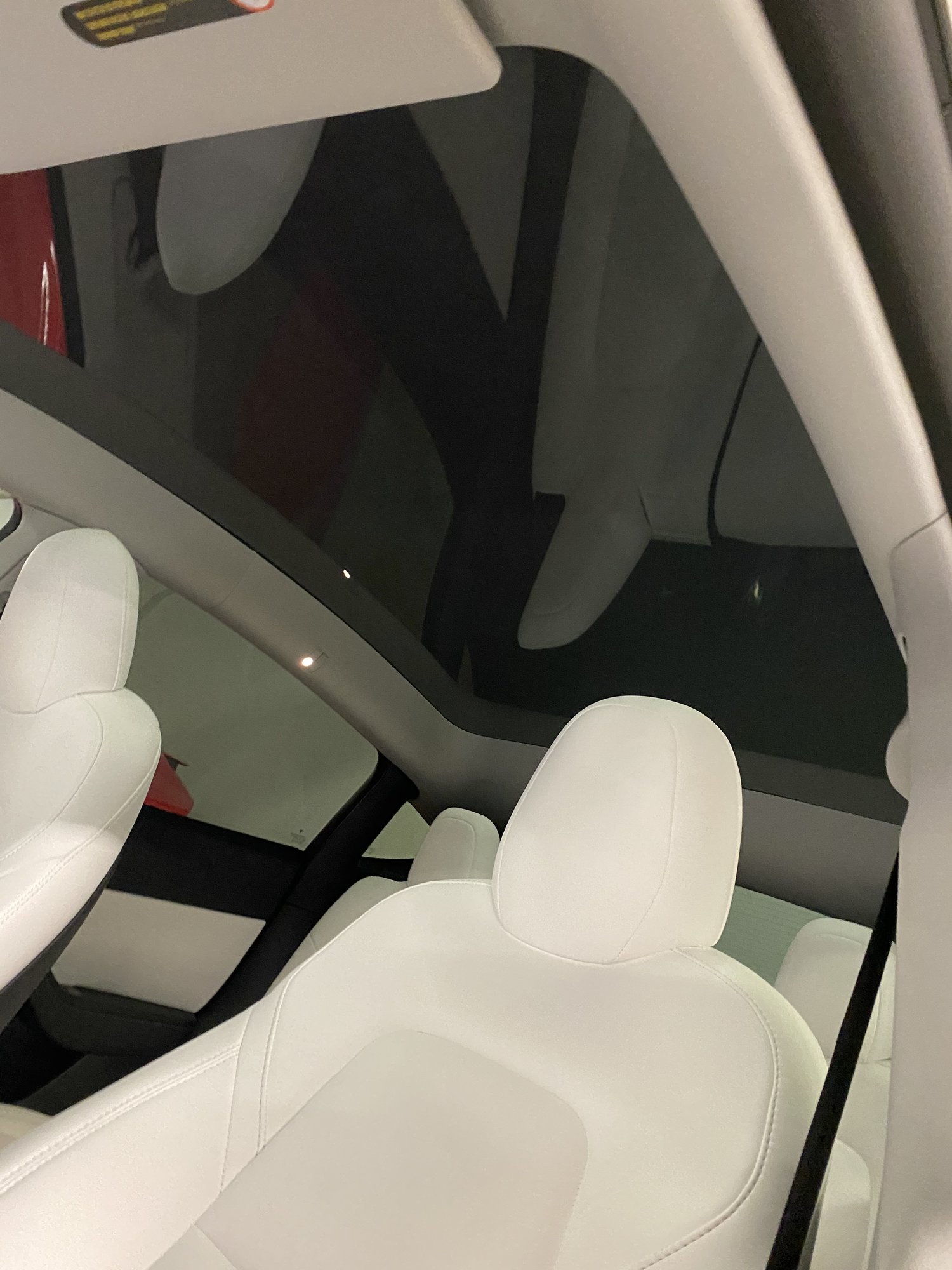 Red Tesla Model Y with white interior