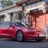 Red Model 3 by a traditional Chinese building