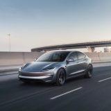 Grey Model 3 driving on a highway