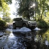 Jeep Recon driving through a stream