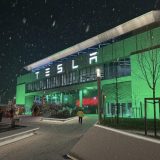 Tesla Giga Berlin building lit green at night