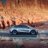 Silver Model Y in a red rock canyon