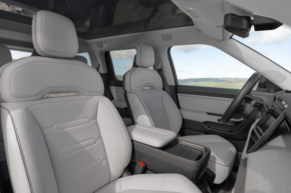 Light grey front seats and dashboard inside the Rivian R2