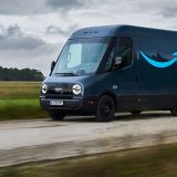 Amazon Prime electric delivery van built by Rivian driving on a country road