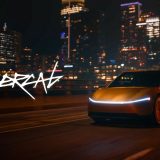 Gold Cybercab driving in a city at night