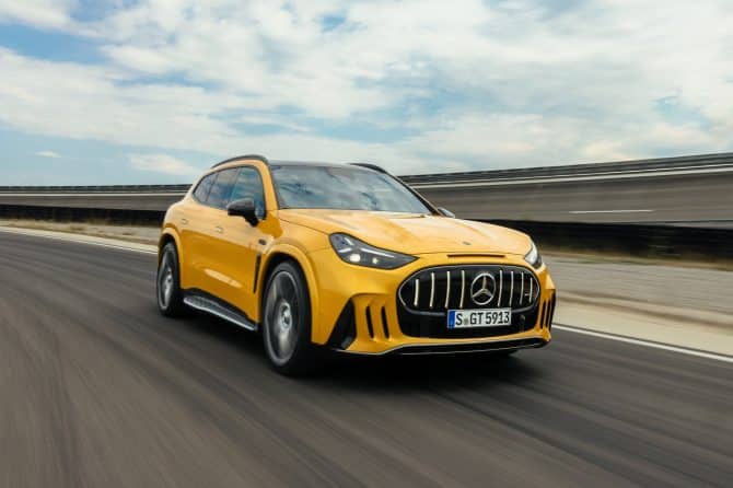 Yellow Mercedes-AMG GT 63 SUV driving on a test track, front three-quarter view
