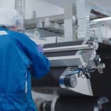 Technician in a clean suit working on battery prototyping at GM's Battery Cell Innovation Center in Warren, Michigan