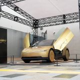 Gold Tesla Cybercab with its doors open at its Japan debut