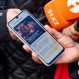 Smartphone showing Beeline Kazakhstan's Starlink satellite-to-mobile service at a launch event