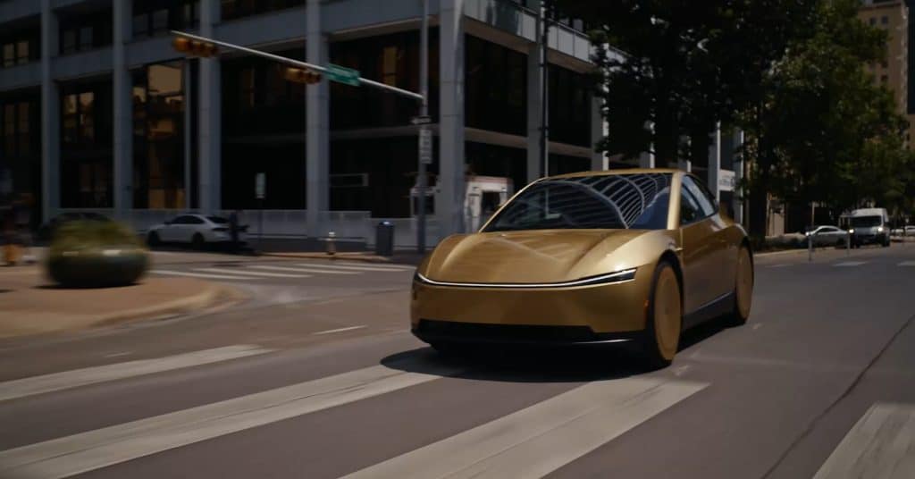 Gold Tesla Cybercab driving through a downtown Austin intersection