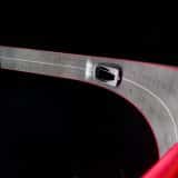 Overhead view of the white Tesla Roadster driving on a red-edged banked track