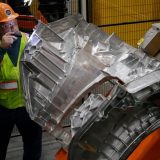Ford team member inspects a large aluminum unicasting for the Fathom electric truck