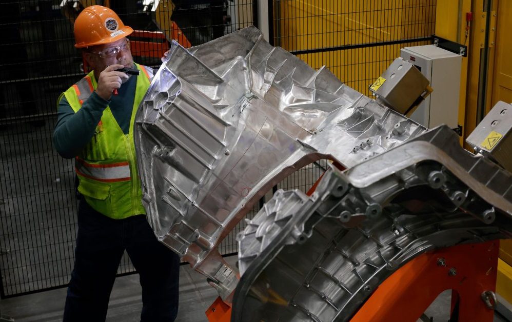 Ford team member inspects a large aluminum unicasting for the Fathom electric truck