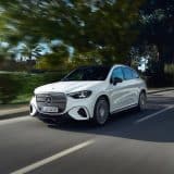 White Mercedes-Benz electric GLC driving on a country road in Portugal