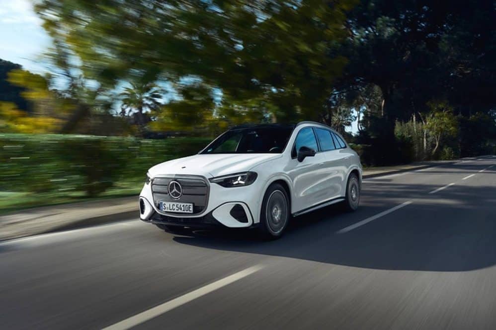 White Mercedes-Benz electric GLC driving on a country road in Portugal
