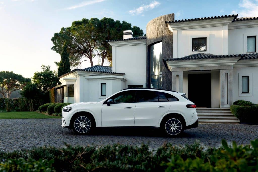 Side profile of the white Mercedes-Benz electric GLC in front of a villa in Portugal