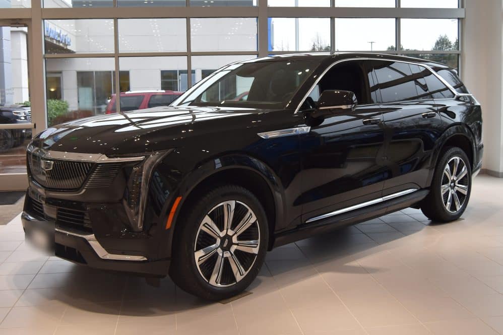 Black Cadillac Escalade IQ electric SUV in a dealership showroom