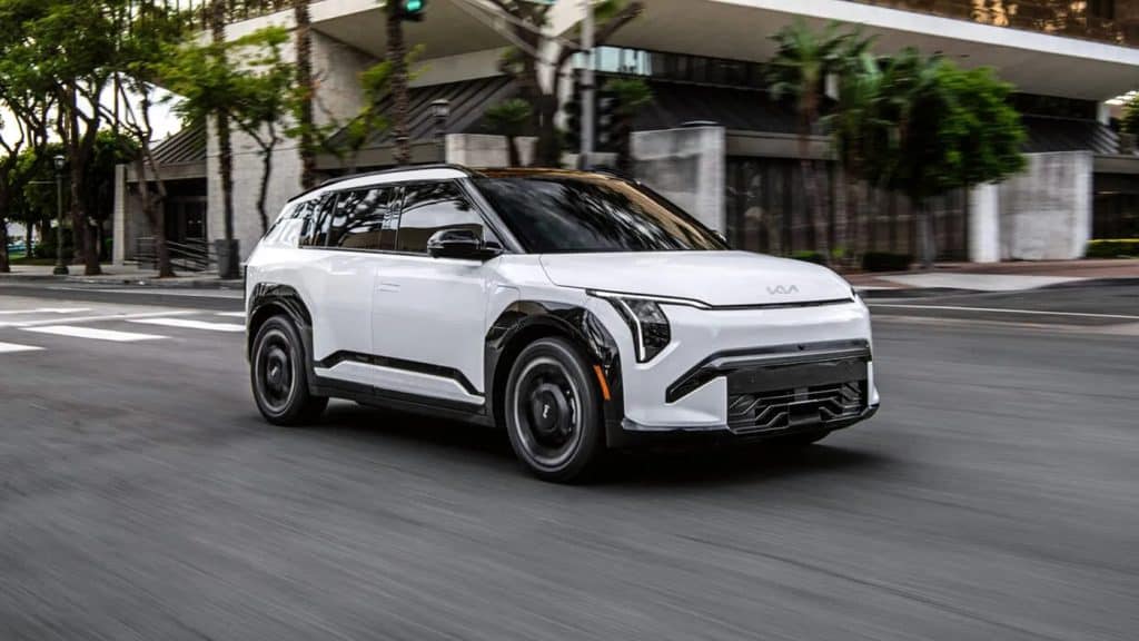 White 2027 Kia EV3 driving on a city street