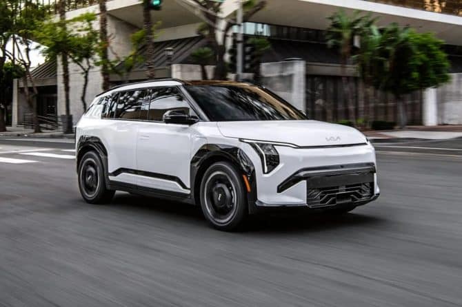 White 2027 Kia EV3 driving on a city street