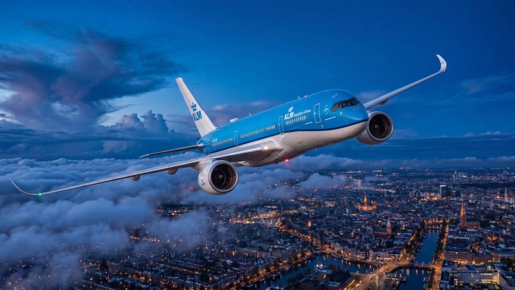 KLM jet flying above clouds at dusk