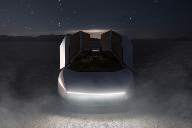 The new Tesla Roadster at night in the desert with dust kicked up under a starry sky