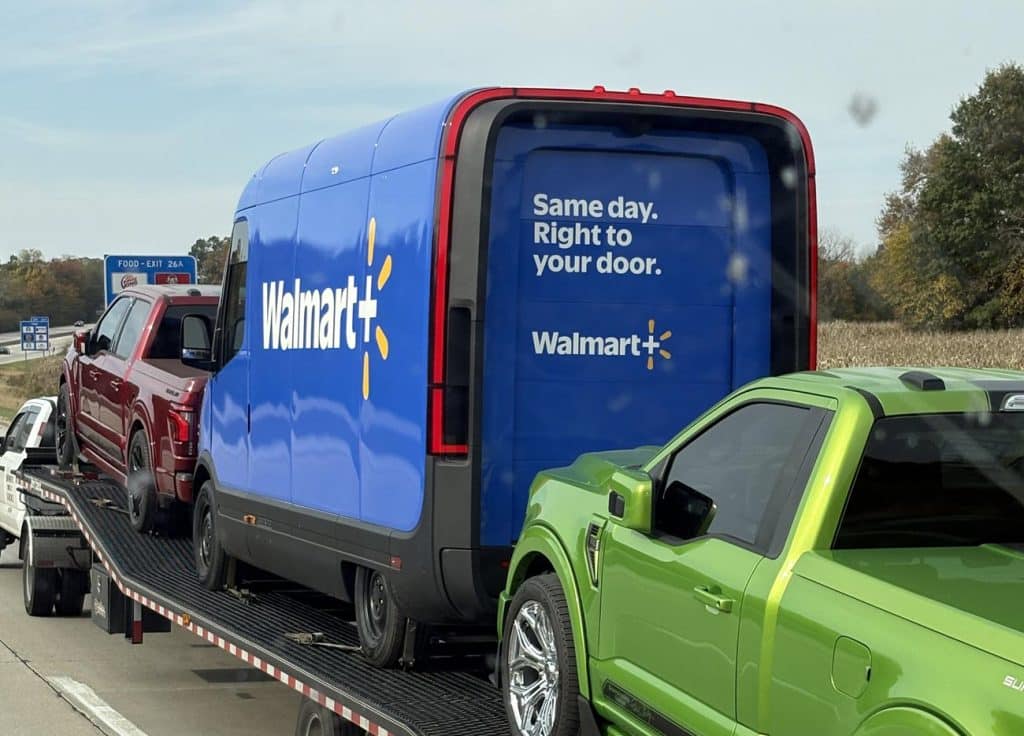 a rivian electric delivery van with a walmart+ logo