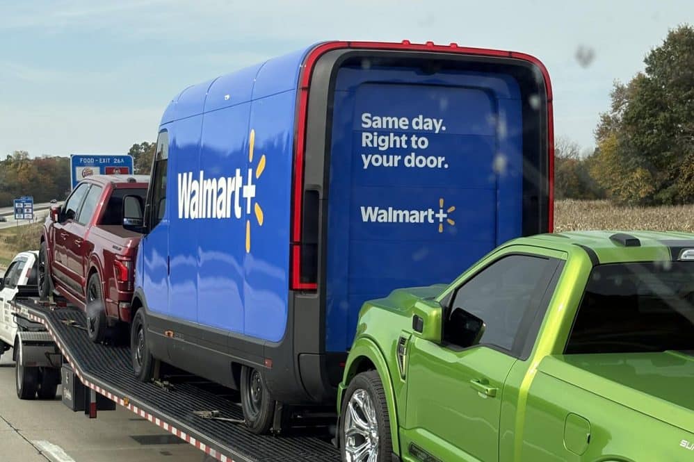 a rivian electric delivery van with a walmart+ logo